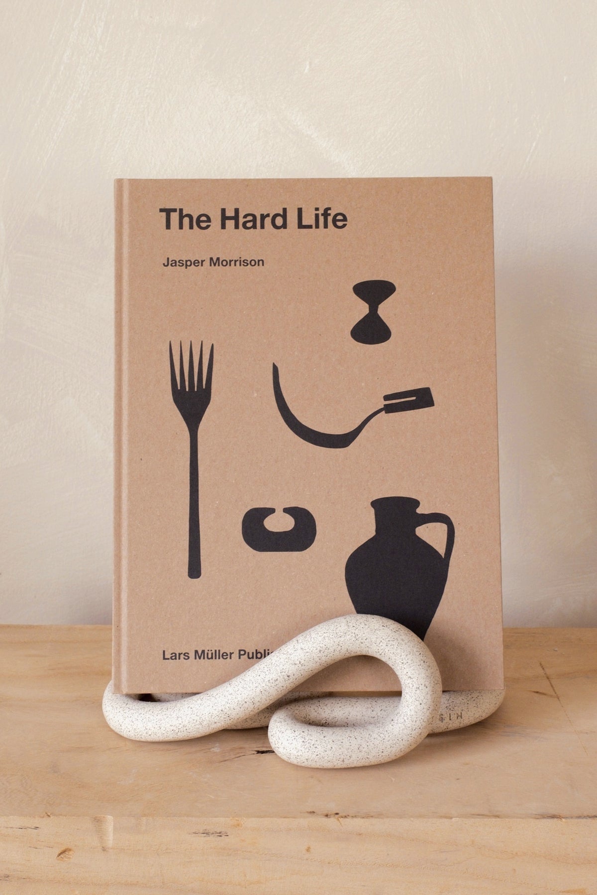 Sin Ceramics Lumbra book stand in sand holding a book