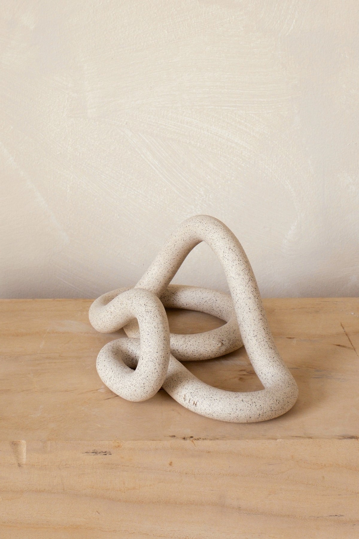 Sin Ceramics Lumbra book stand in sand, angled view