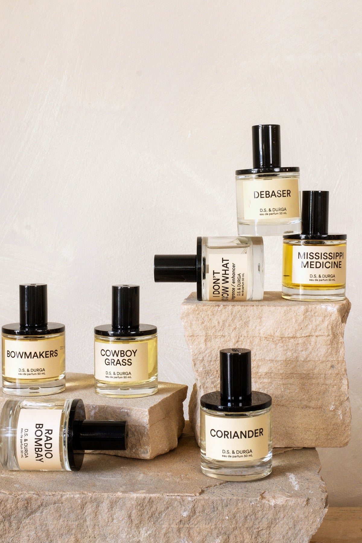 D.S. & Durga perfume collection arranged on stone